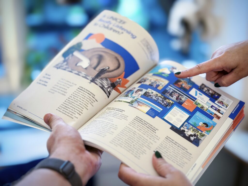 Two people holding the SBC magazine open and pointing at a diagram while discussing the article.